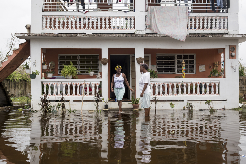 Residents wade through flood waters at their home days after Hurricane Maria made landfall, on Sept. 22, 2017, in Loiza, Puerto Rico. (Alex Wroblewski/Getty Images)